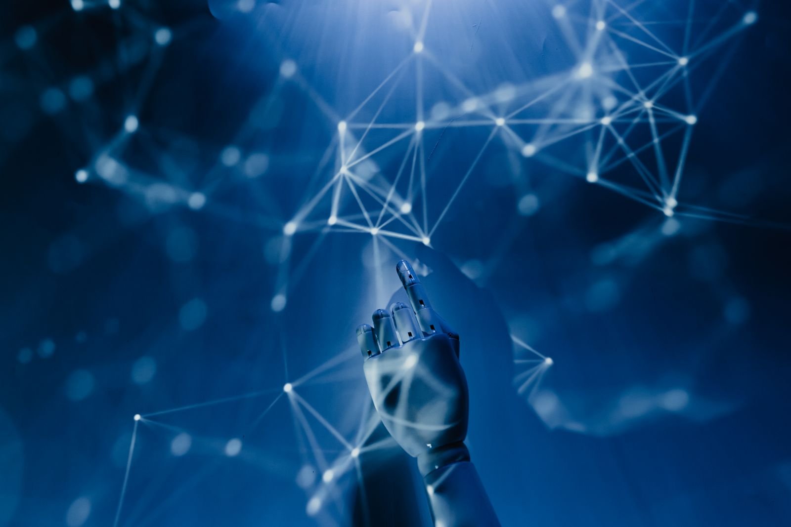 Robotic hand reaching toward a network of connected points