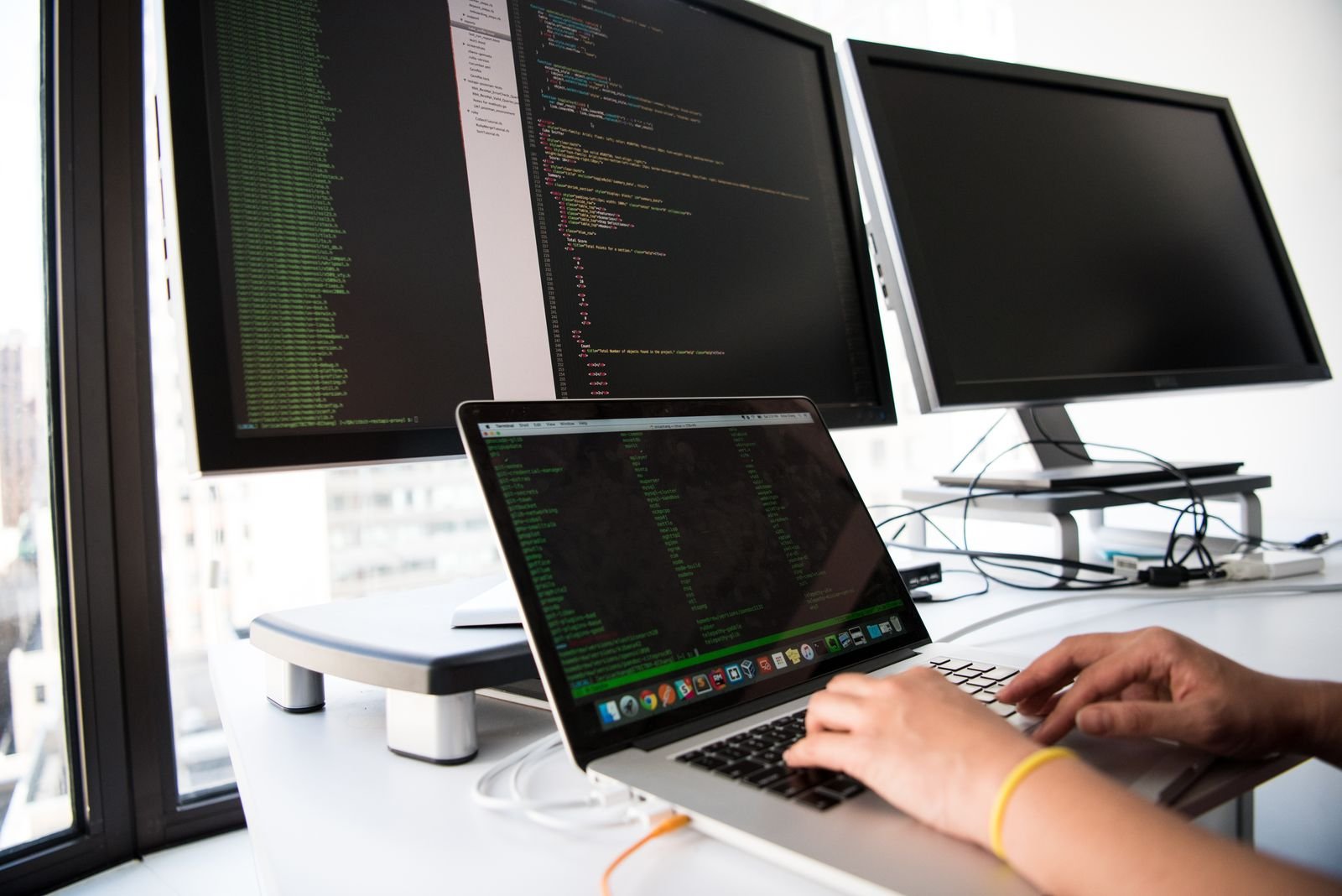 Workstation with two monitors showing source code