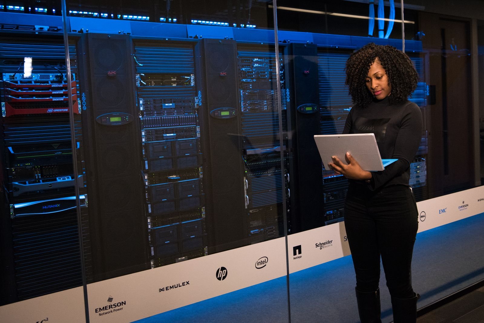 Engineer working on a laptop inside a server room