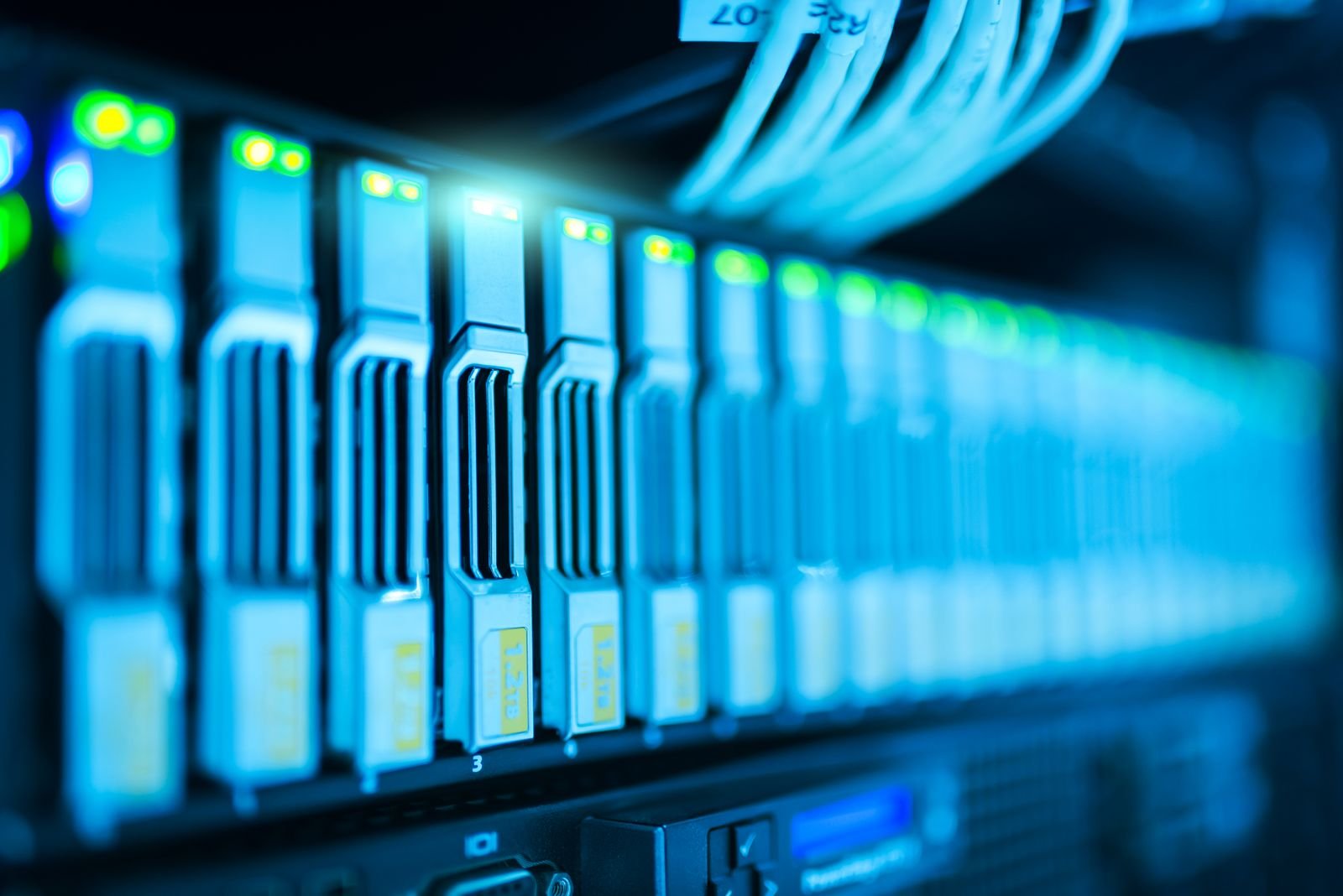 Rows of server racks lit in blue in a data center