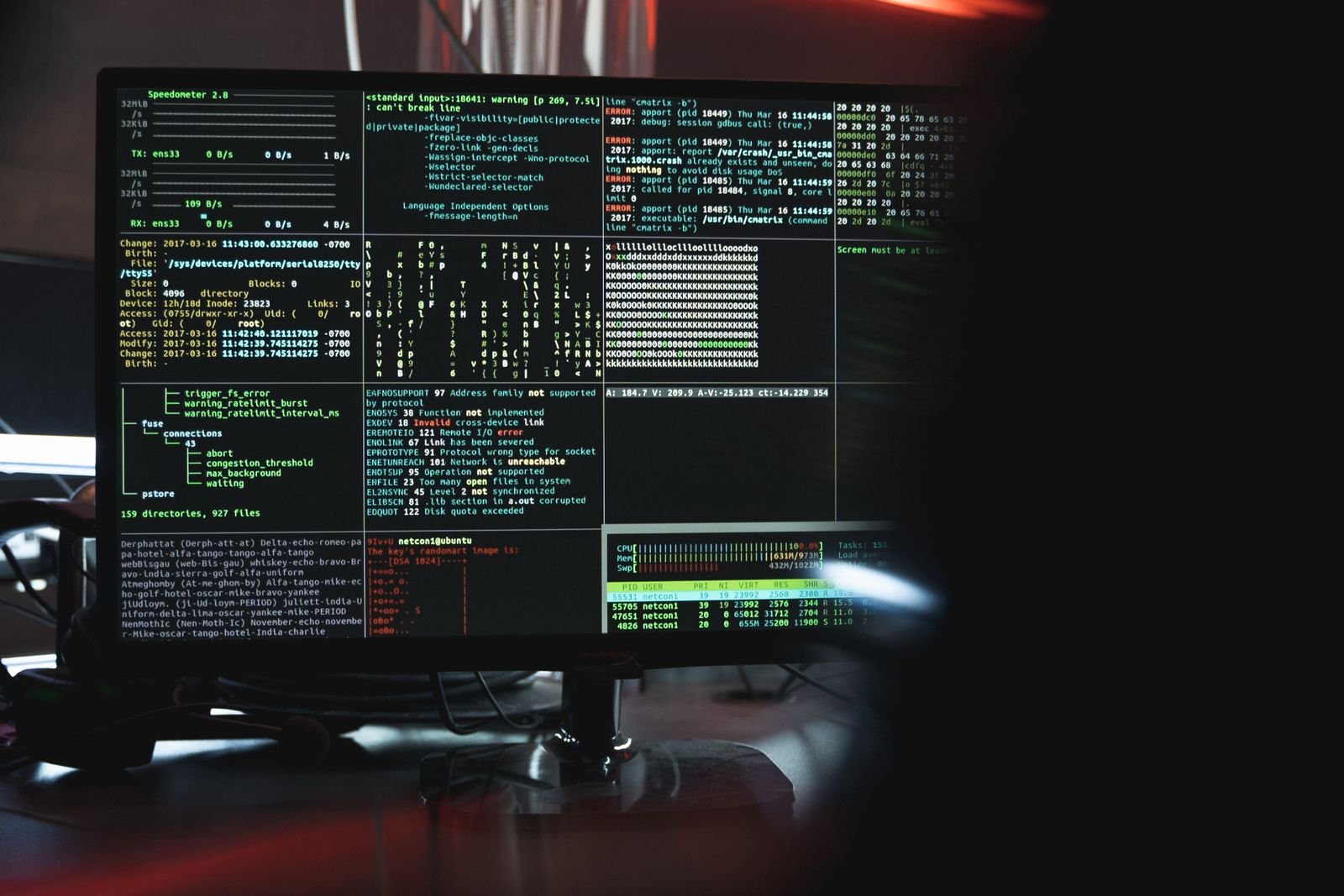 Security operations screens with terminal output in a dark room